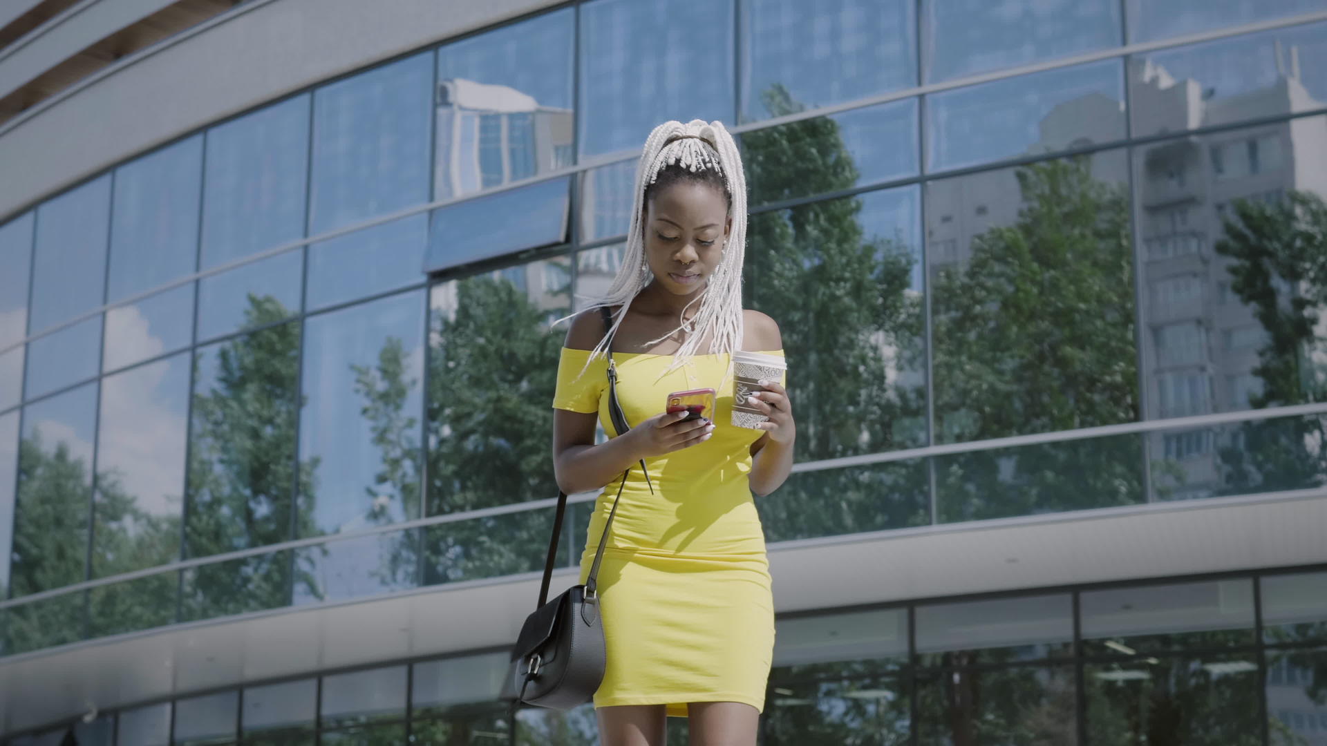 时尚女性在街上使用智能手机视频的预览图