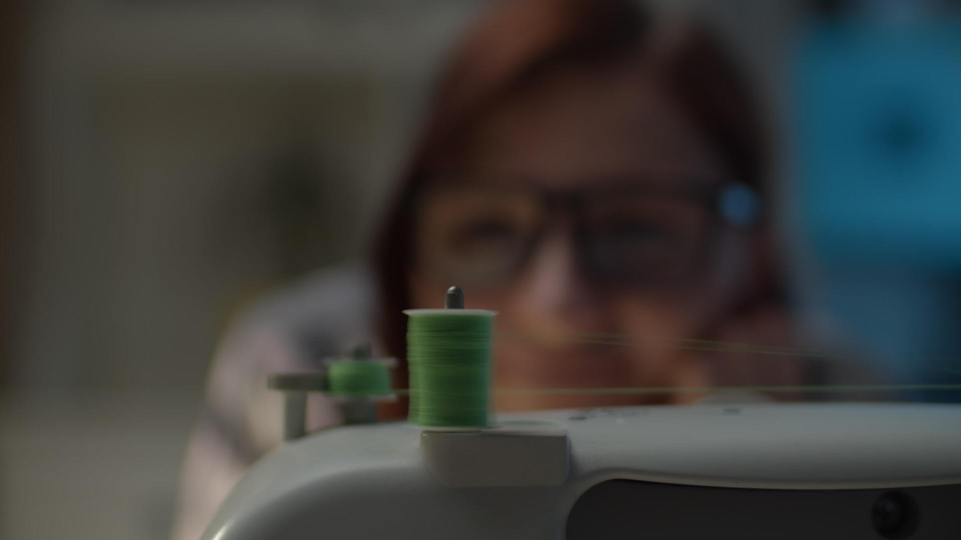 在缝纫机上关闭缠绕线轴的女性视频的预览图