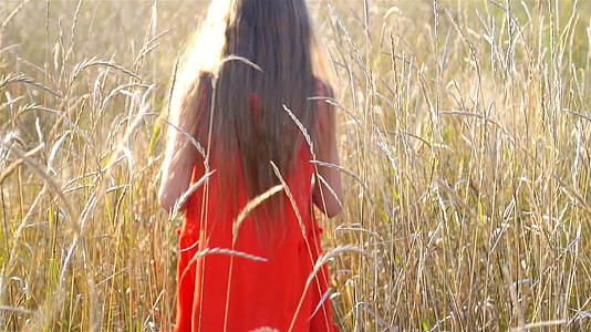 一个漂亮的金发女孩开心地笑穿着红色的裙子视频的预览图
