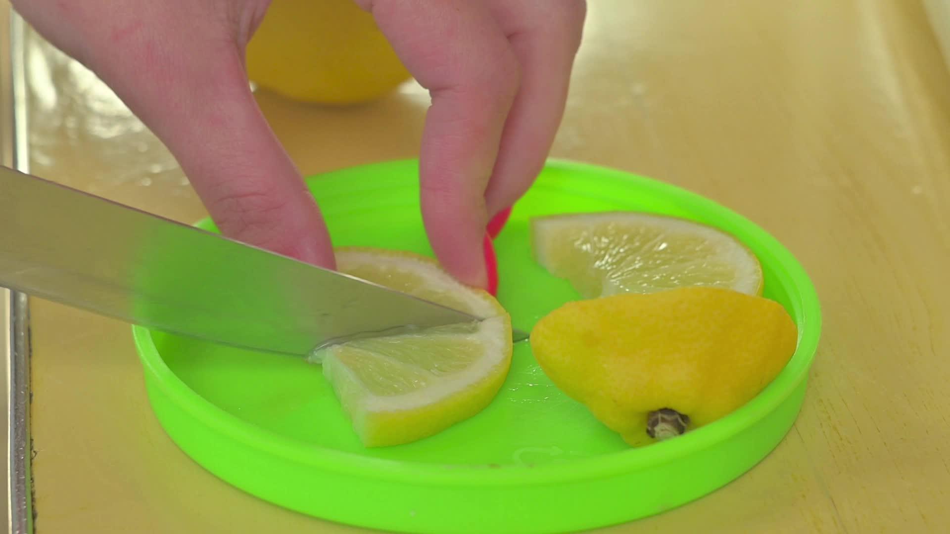 女人手里拿着柠檬用手指切成刀片视频的预览图