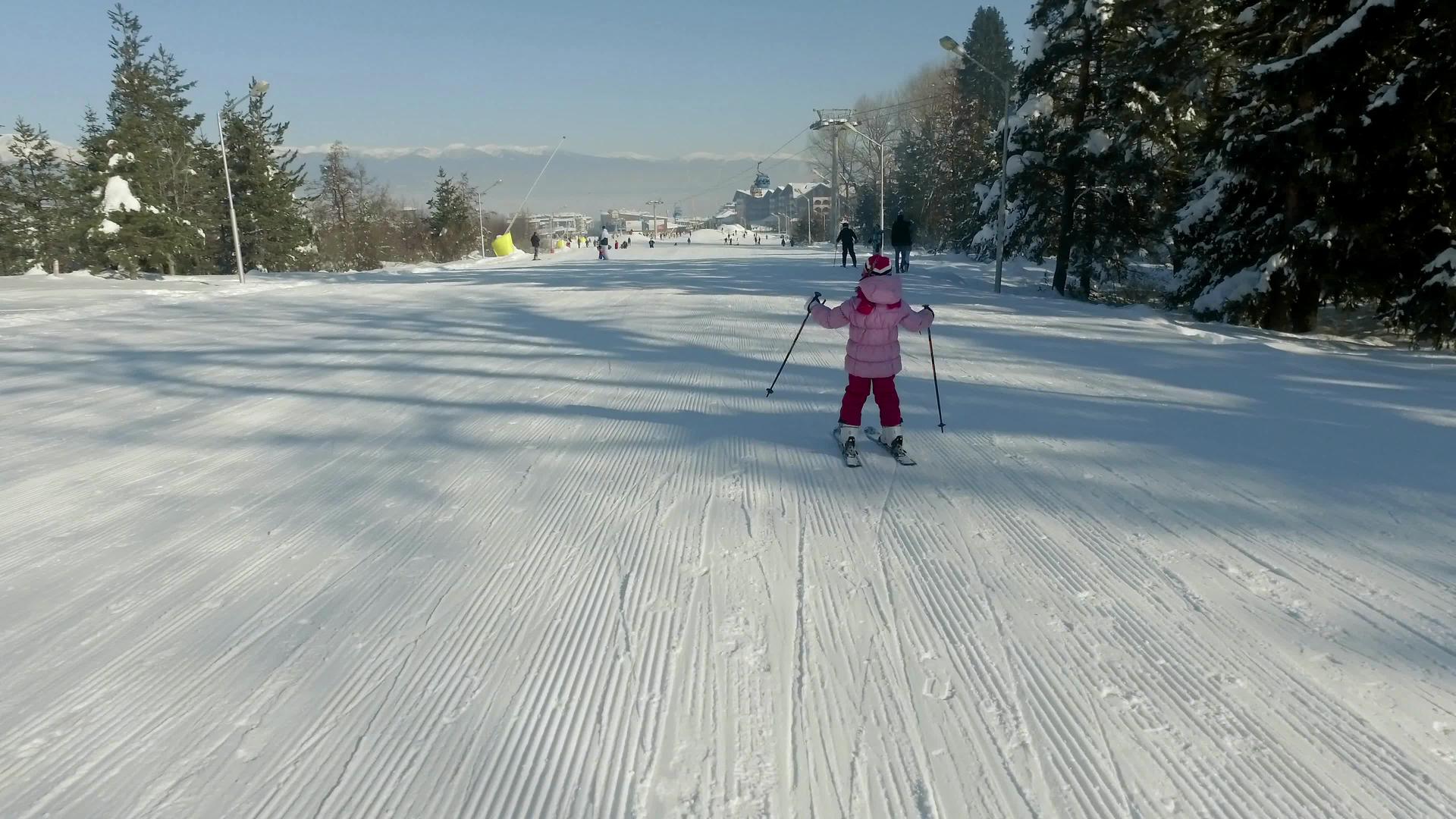 小女孩滑下滑雪坡冲向中间视频的预览图