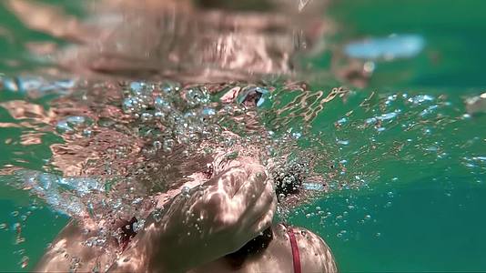 一个女孩在水下慢慢地移动头发视频的预览图