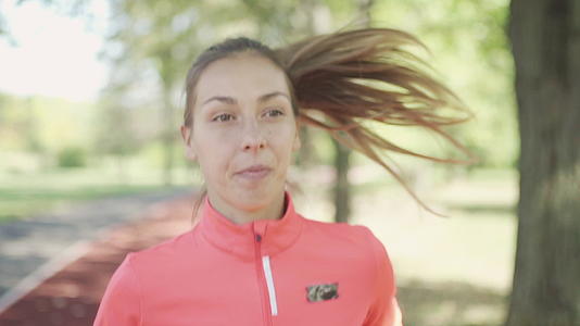 健身跑步女孩在公园跑跑步视频的预览图