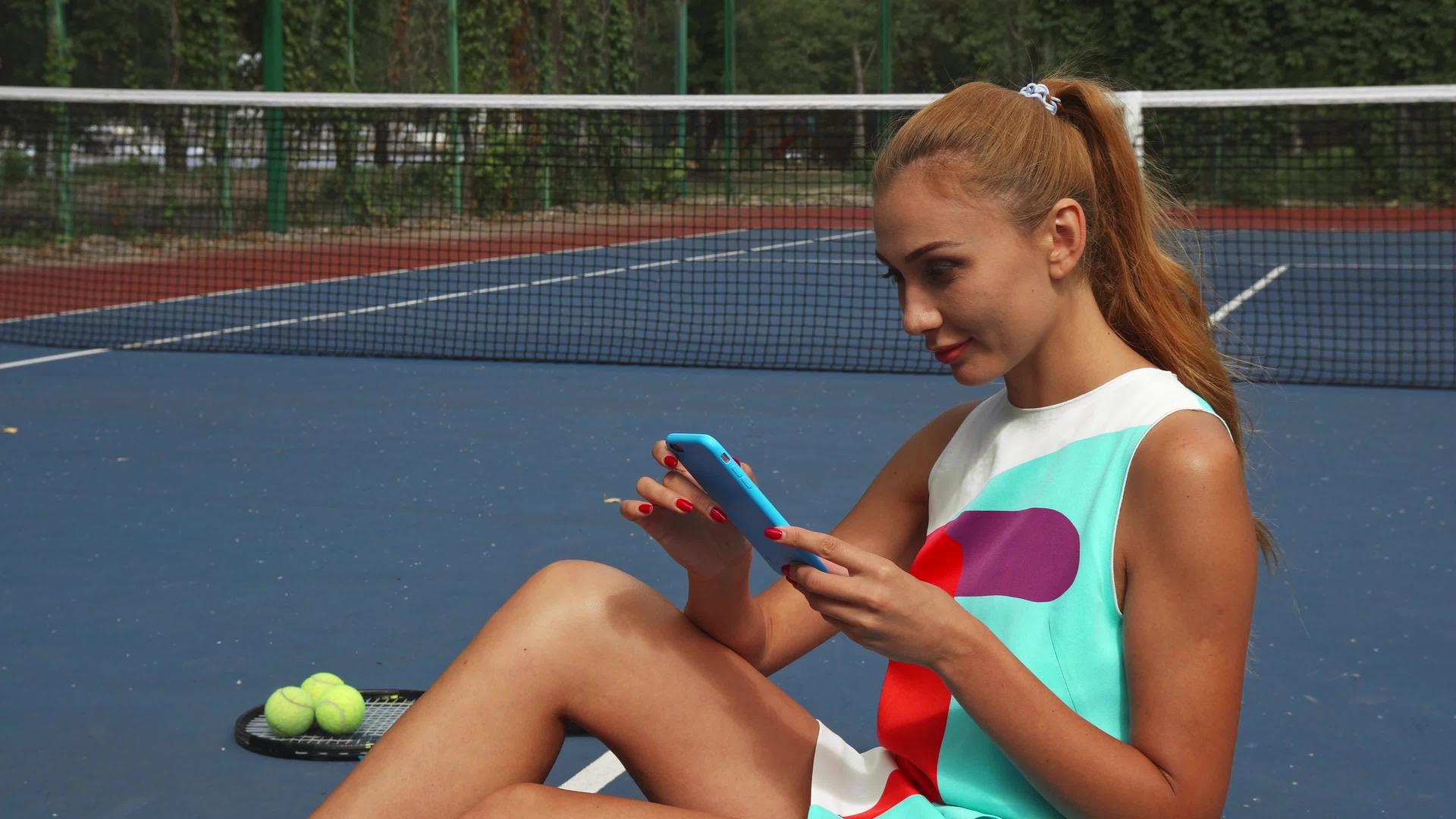 网球女孩在放松时上网冲浪视频的预览图