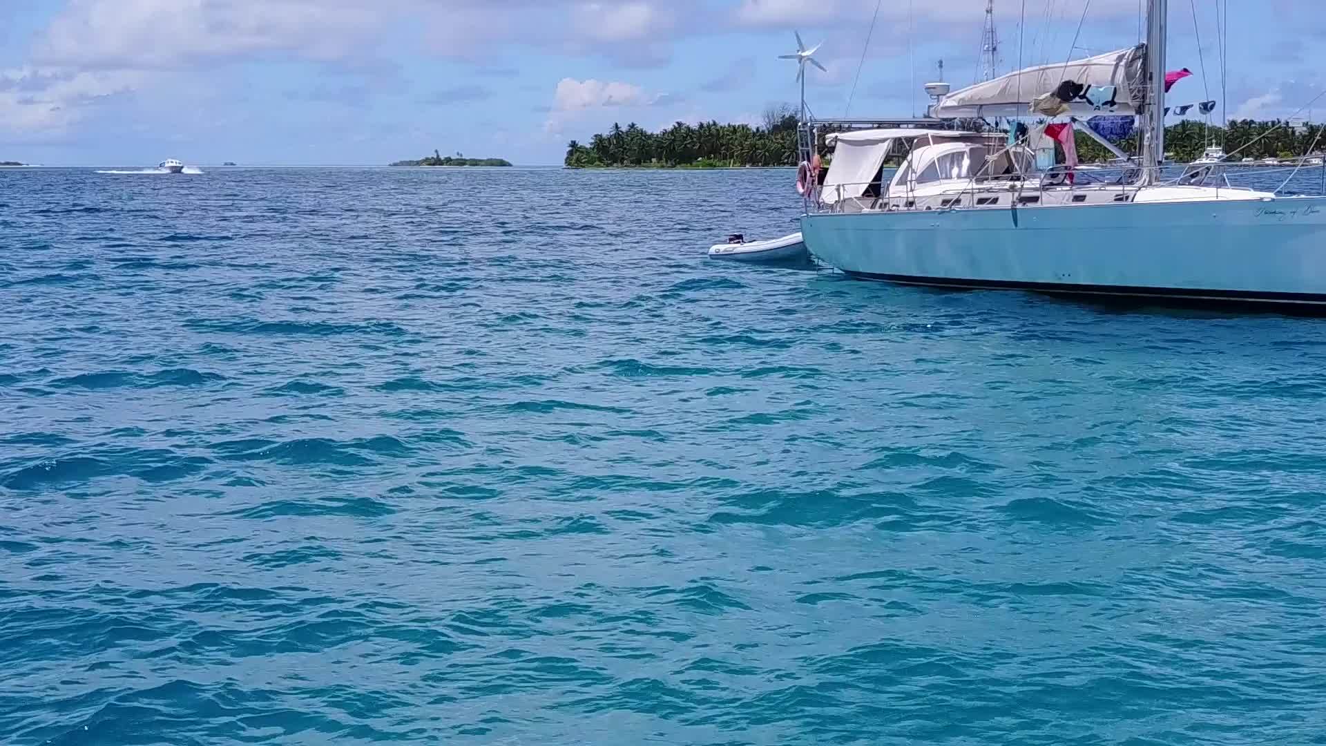 浅环礁湖和接近冲浪的白色海滩的背景是阳光明媚的海岸视频的预览图