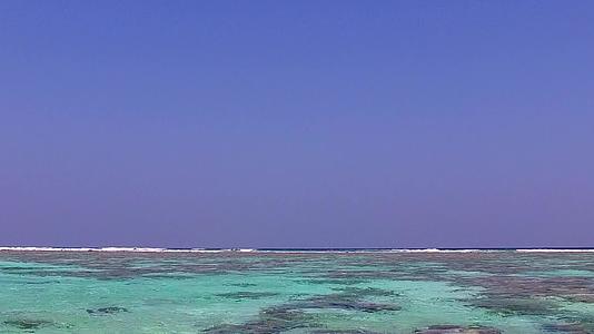 日出后以水蓝环礁湖和白沙为背景的热带海岸海滩度假胜地视频的预览图