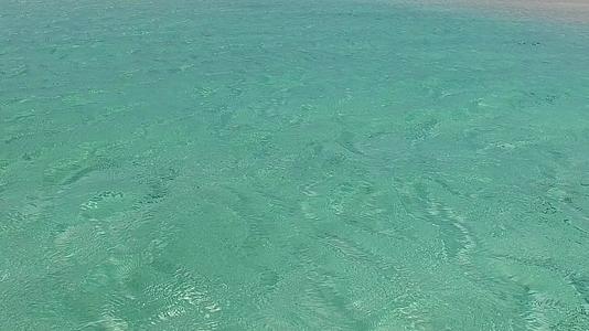 珊瑚礁附近的白沙背景蓝绿色泻湖的异国情调海景海滩生活方式视频的预览图