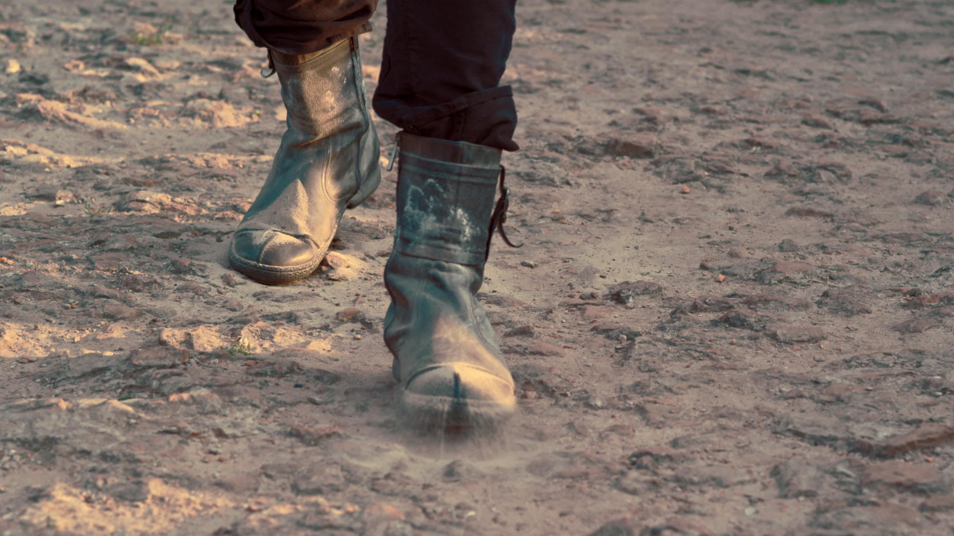 男子穿着脏鞋子步行在泥地视频的预览图