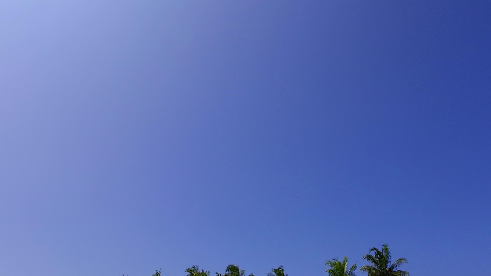 蓝色的大海和珊瑚礁附近的白沙背景享受天堂海滩生活视频的预览图