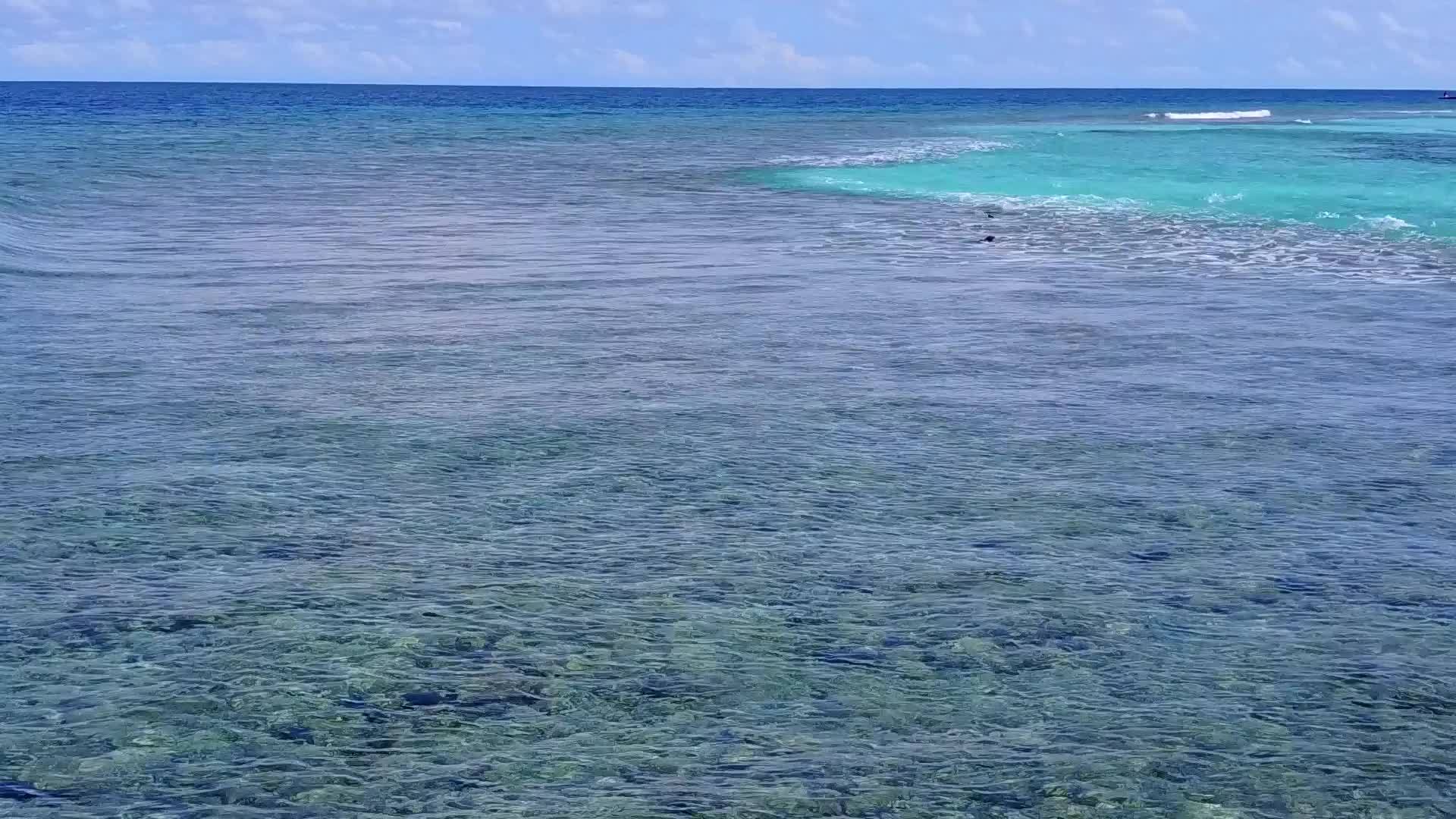 透过蓝绿色的大海海滩附近有明亮的沙尘背景观看海滩时间视频的预览图