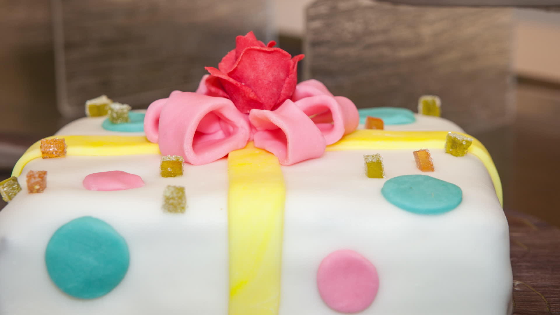 彩色白色蛋糕粉色玫瑰和黄色弓视频的预览图