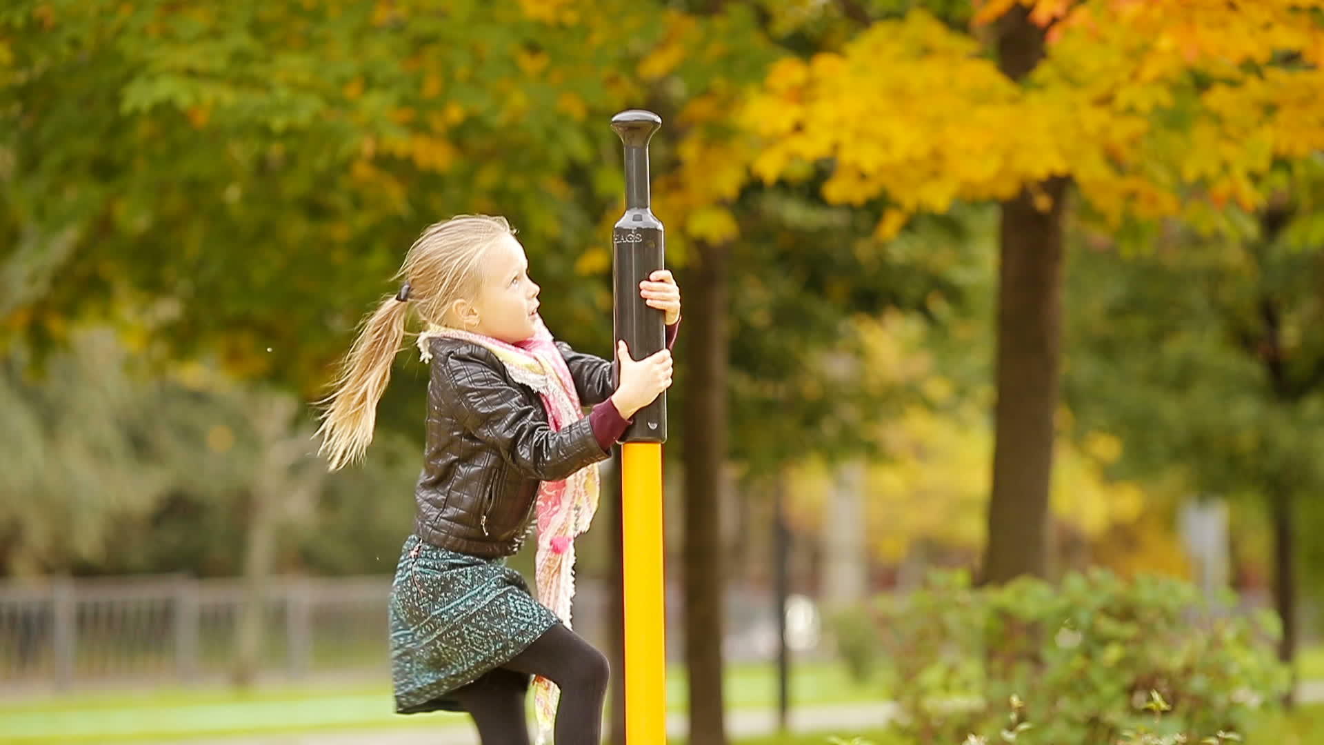可爱的小女孩在秋天的户外操场上玩耍视频的预览图