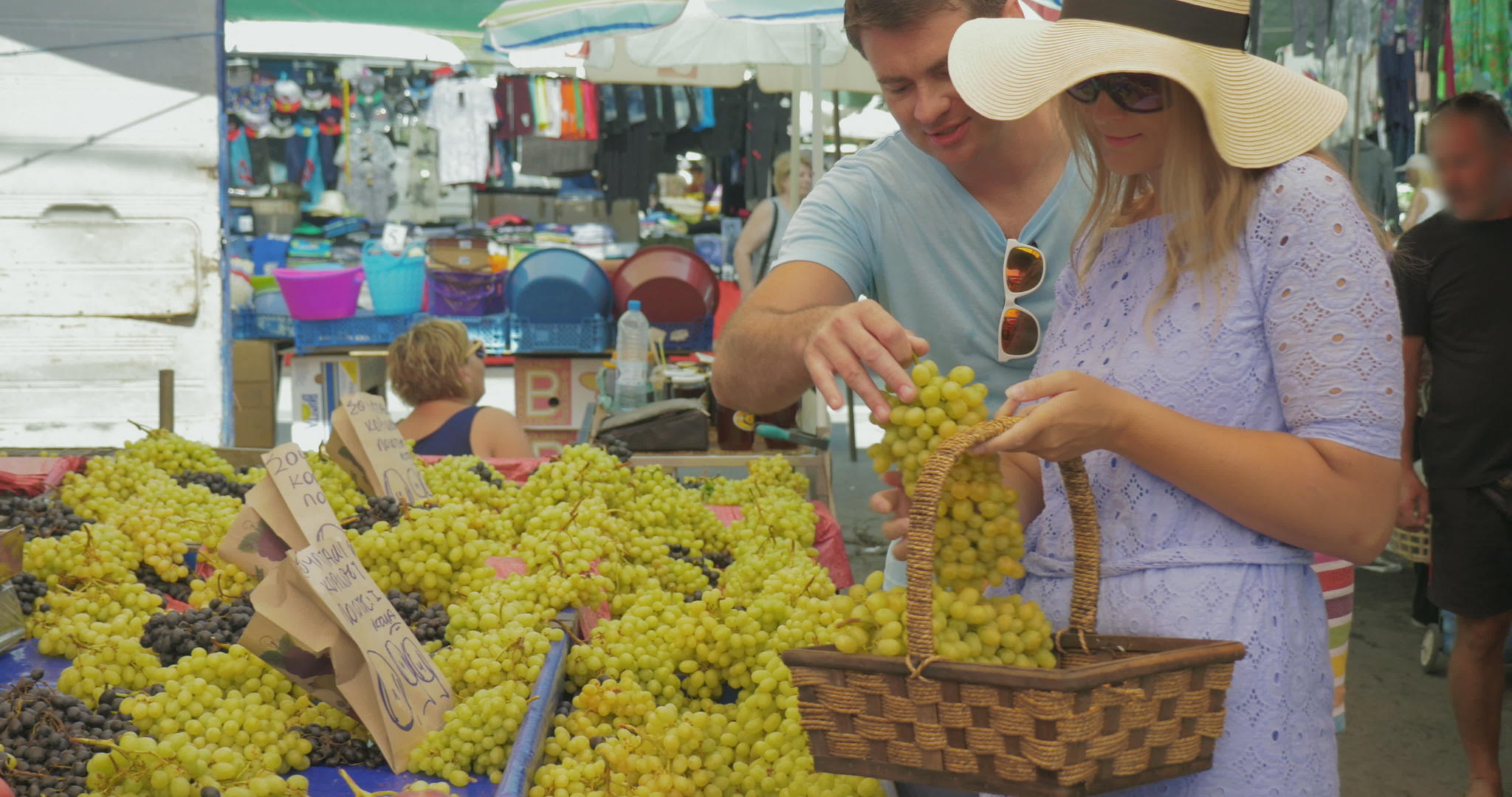 丈夫和妻子选择葡萄在户外市场微笑着说笑话...视频的预览图