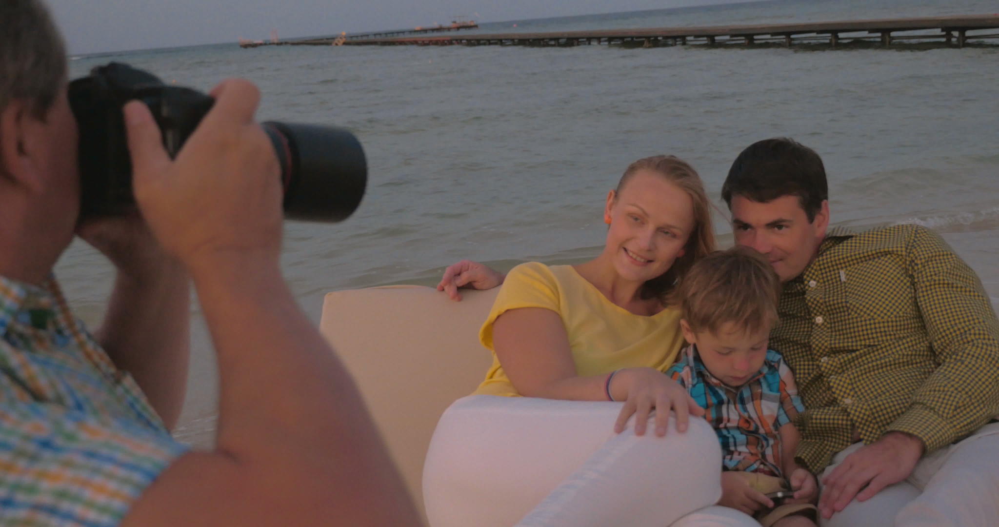 拍下海边家庭的照片视频的预览图