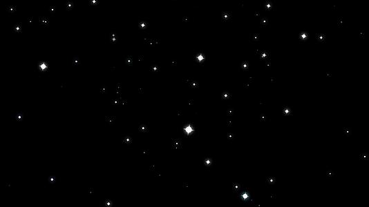 模糊的恒星在黑屏背景下旋转闪闪发光的粒子慢慢褪色视频的预览图
