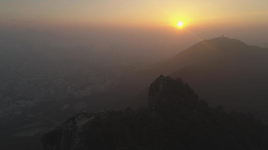 日落时烟雾中的狮子岩和红钟天线在空中观察无人机视频的预览图