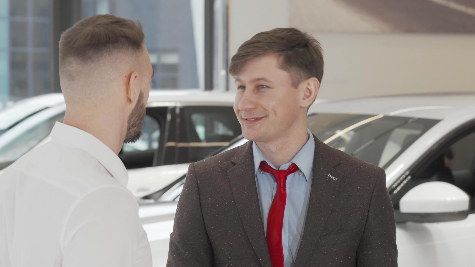 成年男性汽车经销商帮助客户选择新车视频的预览图