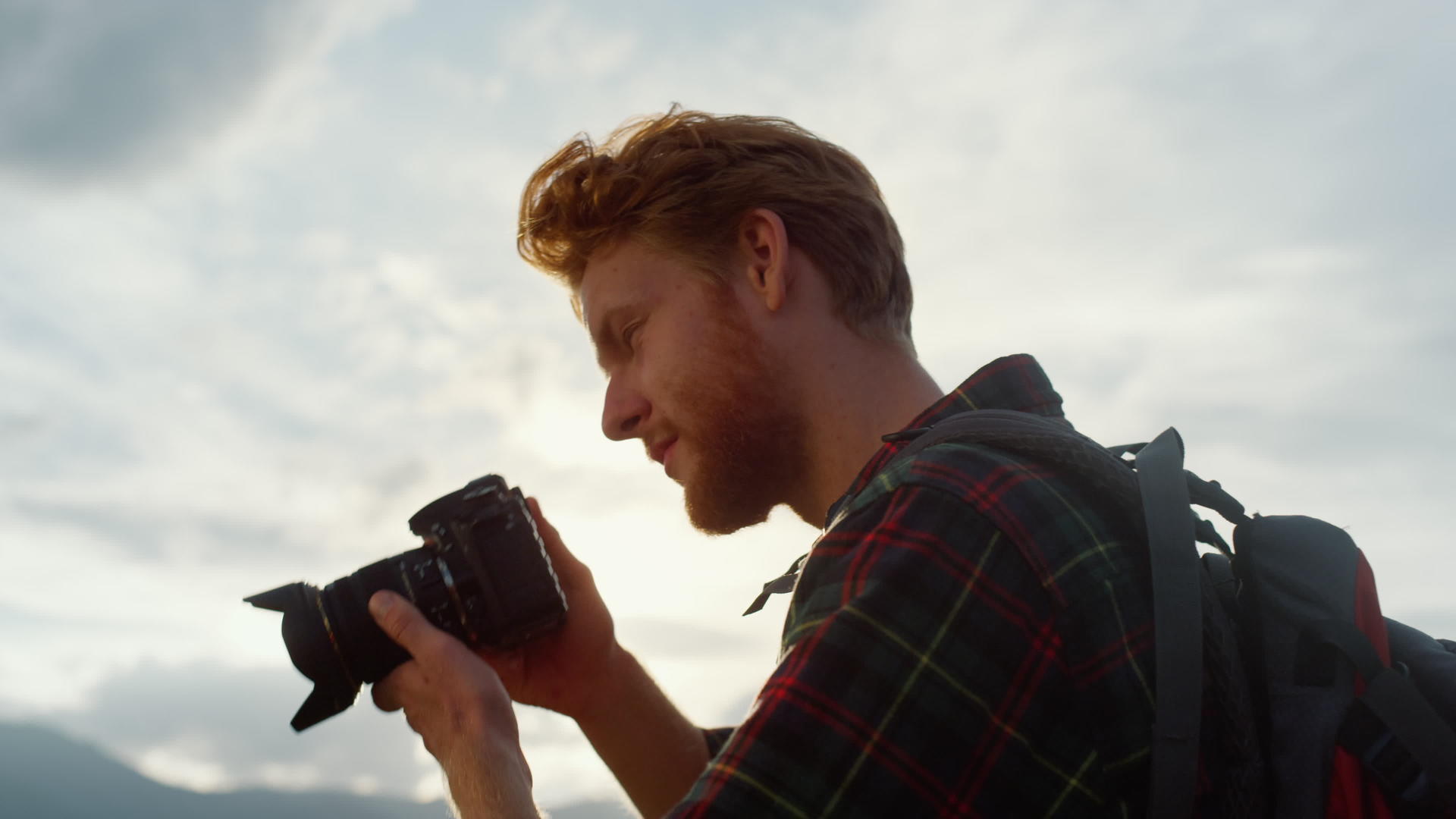 专业摄影师在日落山上自然拍照视频的预览图