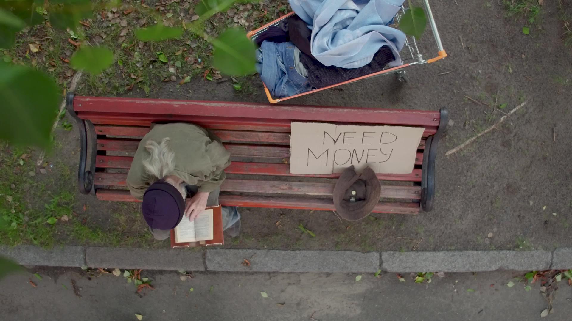 老乞丐坐在长凳上乞讨钱视频的预览图
