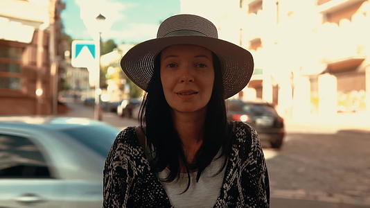 黑发美女戴着帽子在户外摆姿势视频的预览图