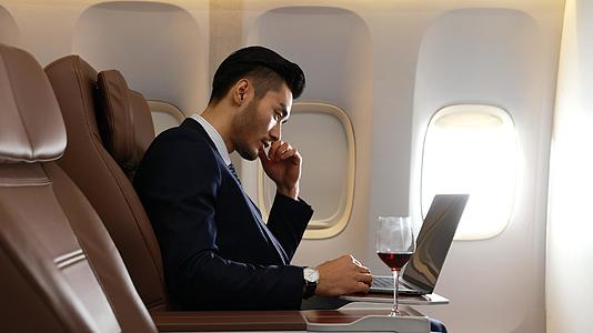 商务男青年出差飞机上喝红酒视频的预览图