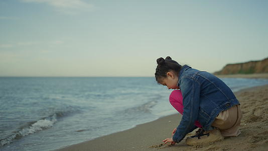 小孩在海上家庭旅行玩沙滩沙滩视频的预览图