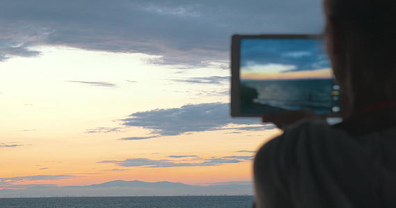 女性拍摄美丽的海景和夜空的照片视频的预览图
