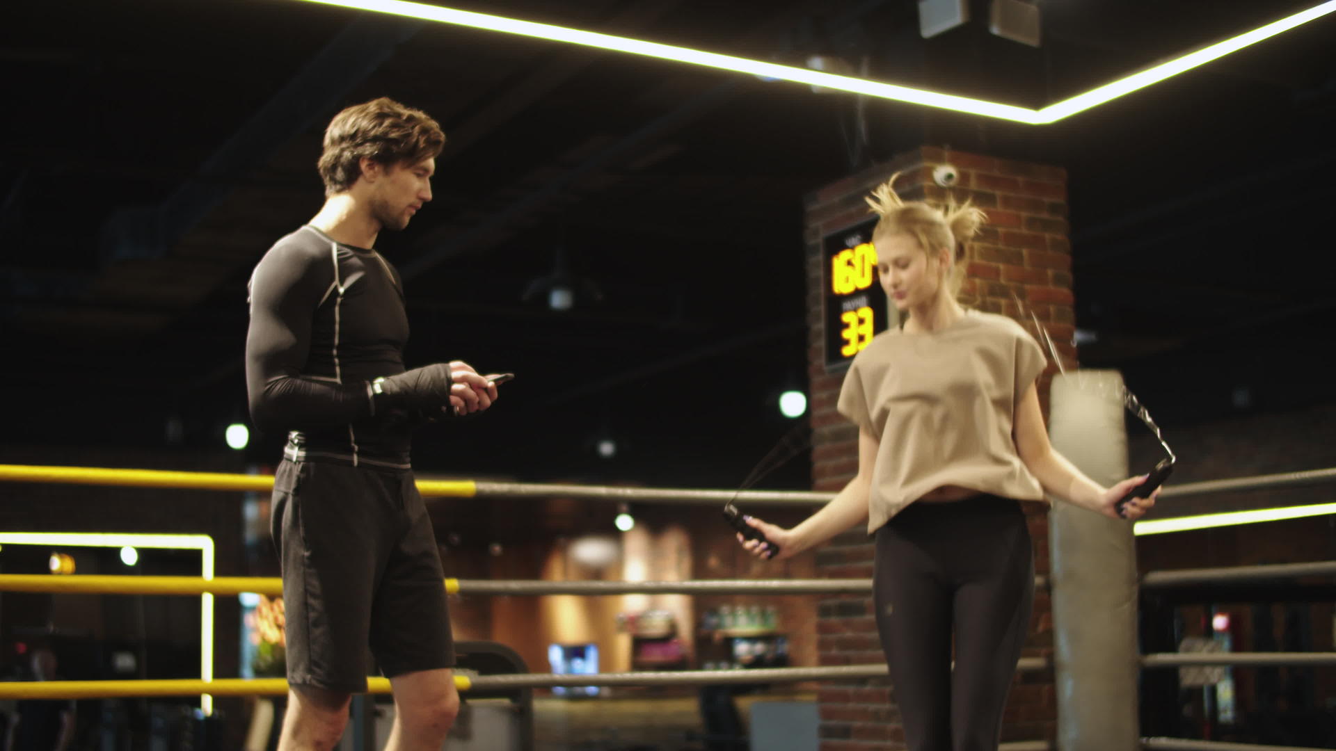 教练在拳击场上控制健身女孩视频的预览图