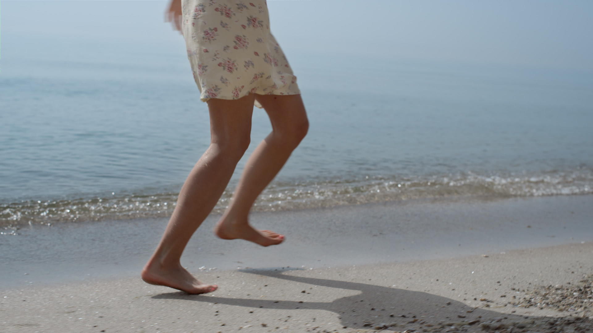 快乐的女人在潮湿的沙滩上旋转弹跳视频的预览图