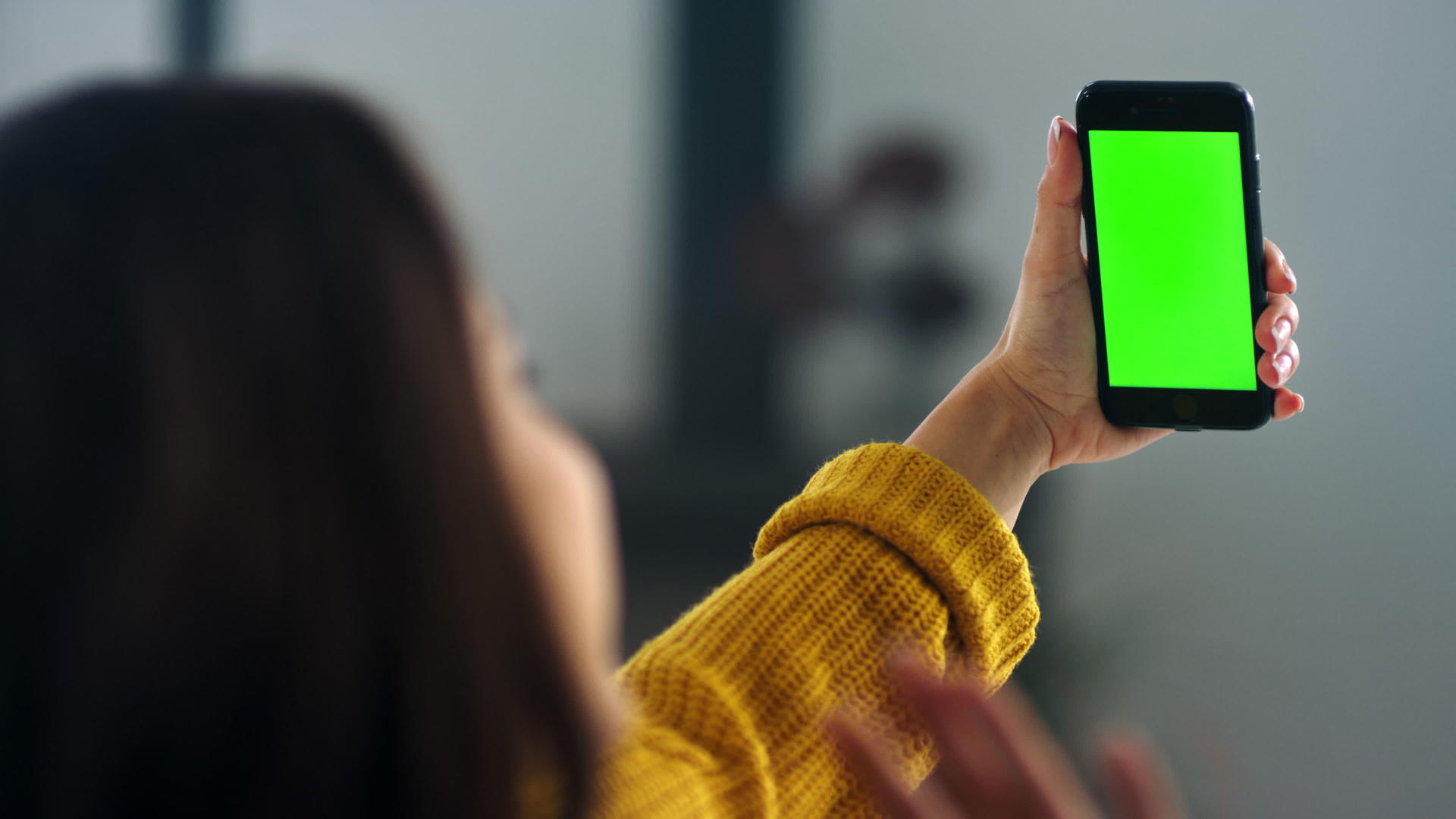 女孩在智能手机上用绿色屏幕进行视频呼叫视频的预览图