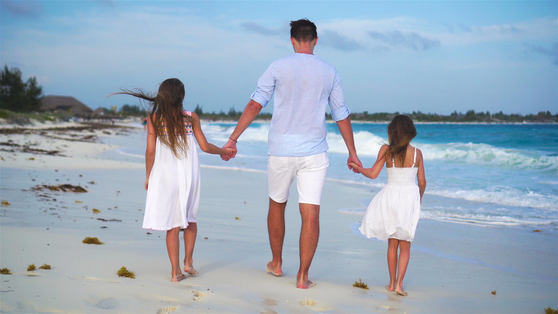 晚上一家人走在卡利比恩岛的白色沙滩上视频的预览图