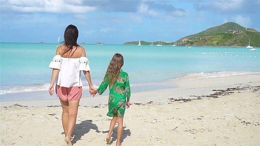 美丽的母亲和女儿在海滩上视频的预览图