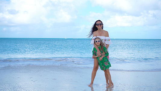 美丽的母亲和小女儿Caribbean海滩玩耍视频的预览图