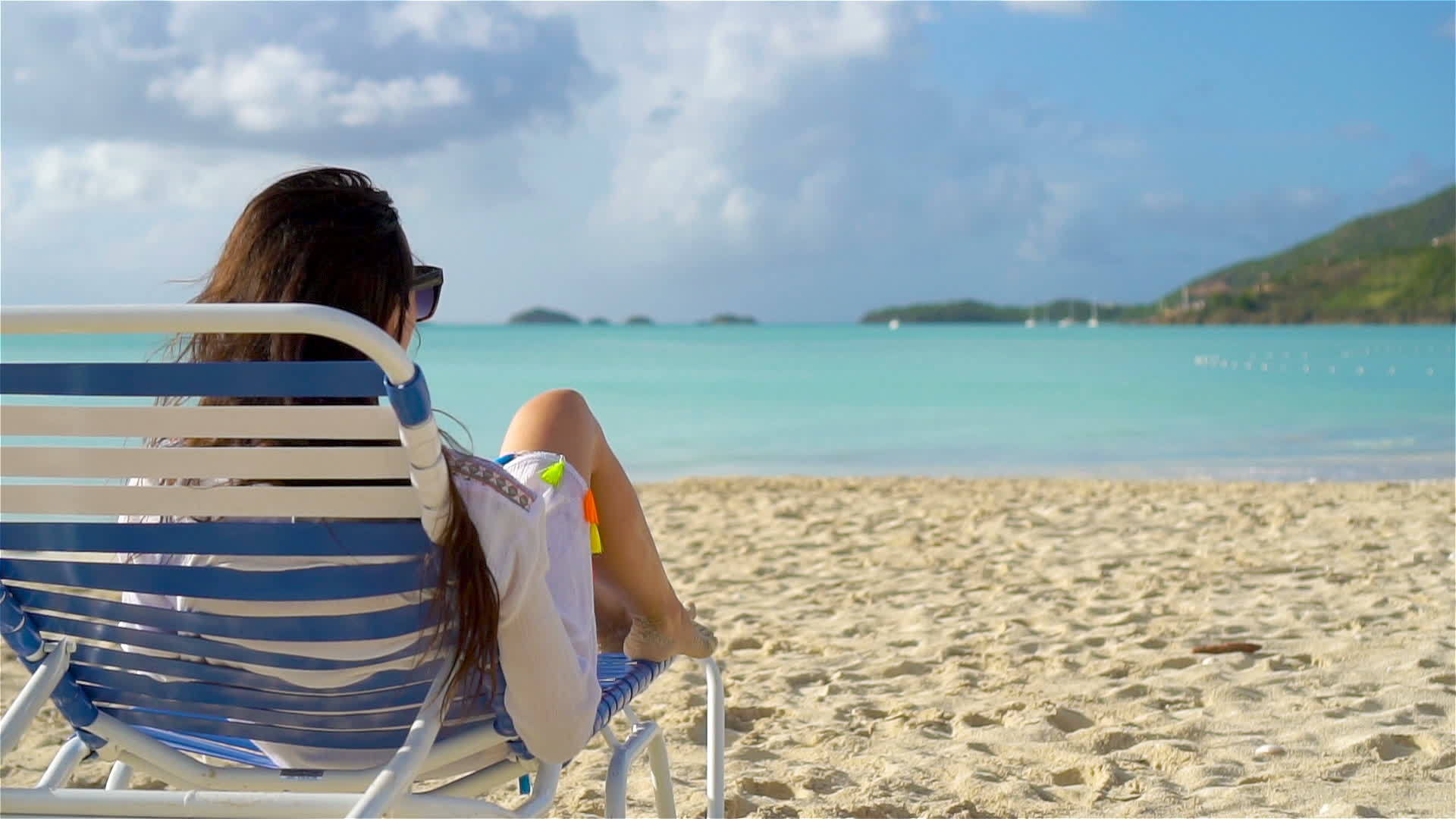 放松享受女人躺在沙滩上晒日光浴的暑假视频的预览图