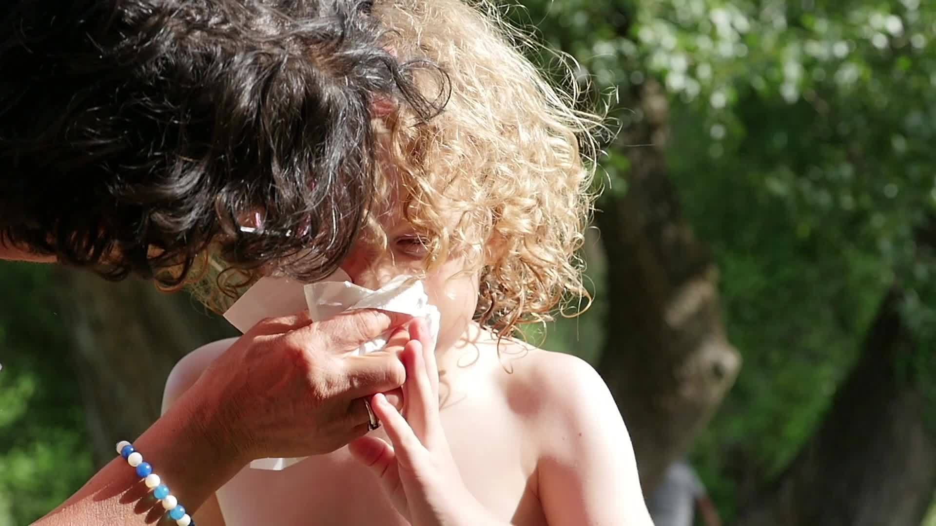 女人吹她的小男孩的鼻子视频的预览图