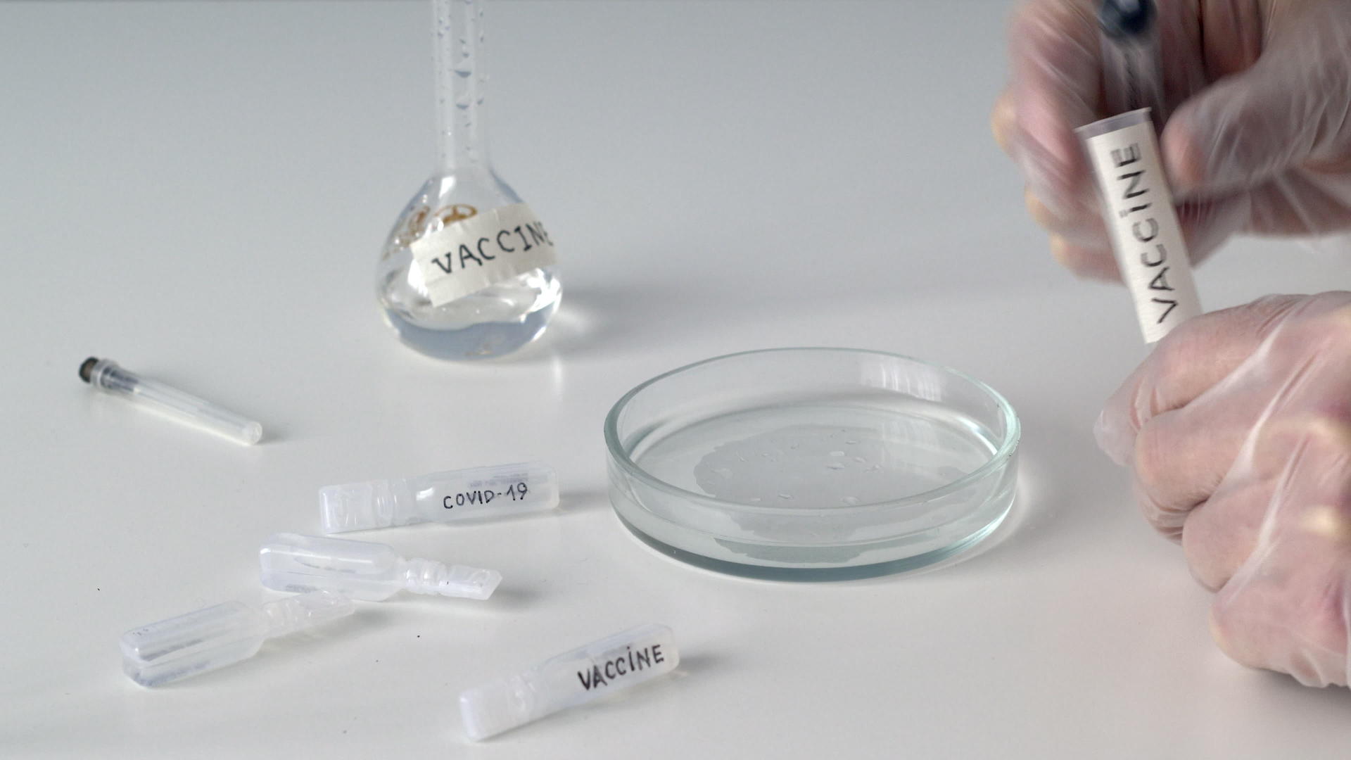 生物学家在科学实验室使用注射器将疫苗液体收集到管理中学家视频的预览图