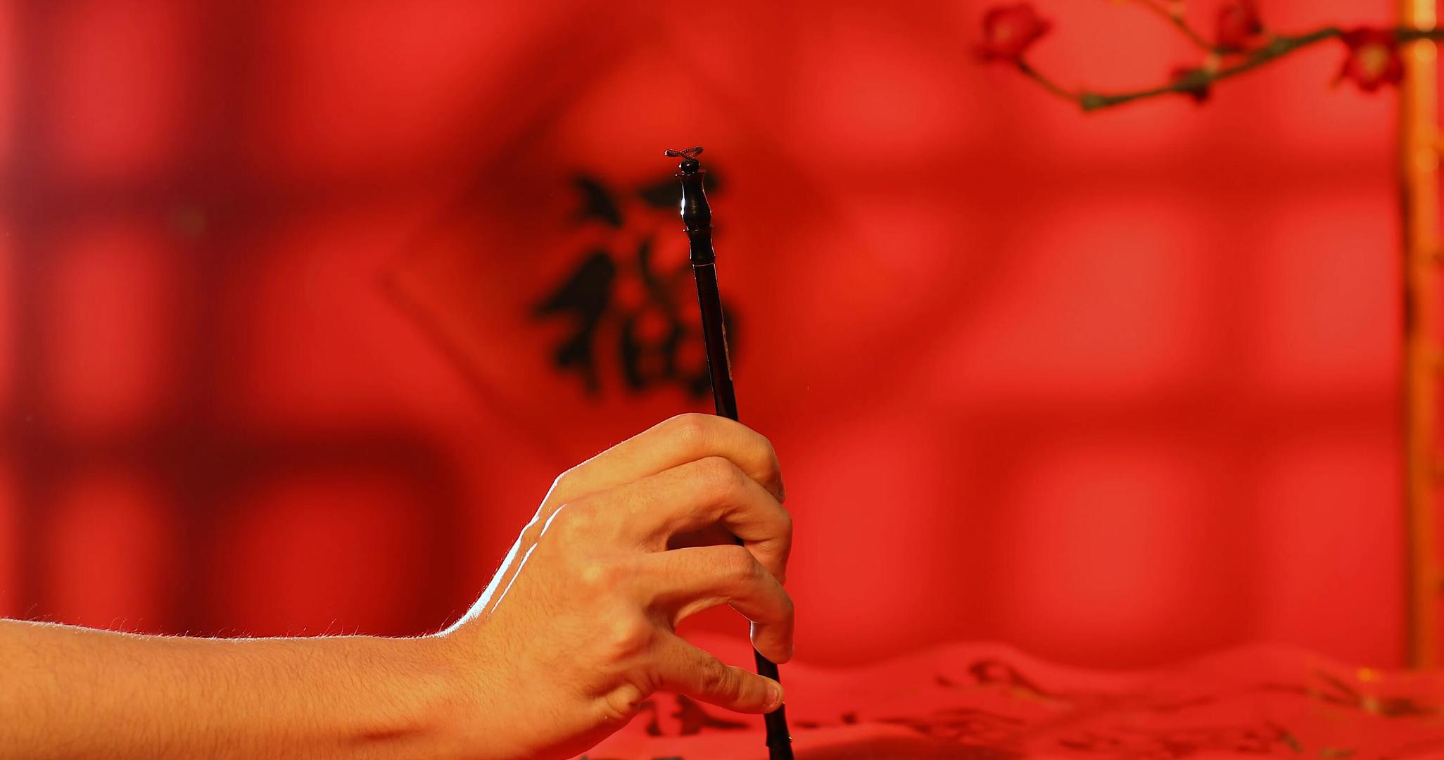 新春书法毛笔字写对联红色背景实拍视频视频的预览图