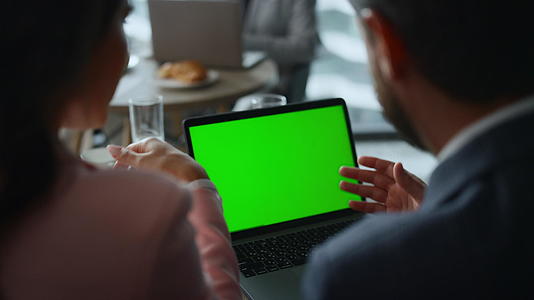 商业夫妇在咖啡馆联合办公的笔记本电脑色度键屏幕上进行视频聊天视频的预览图