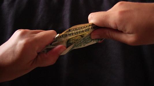 手里拿着一美元的钞票视频的预览图