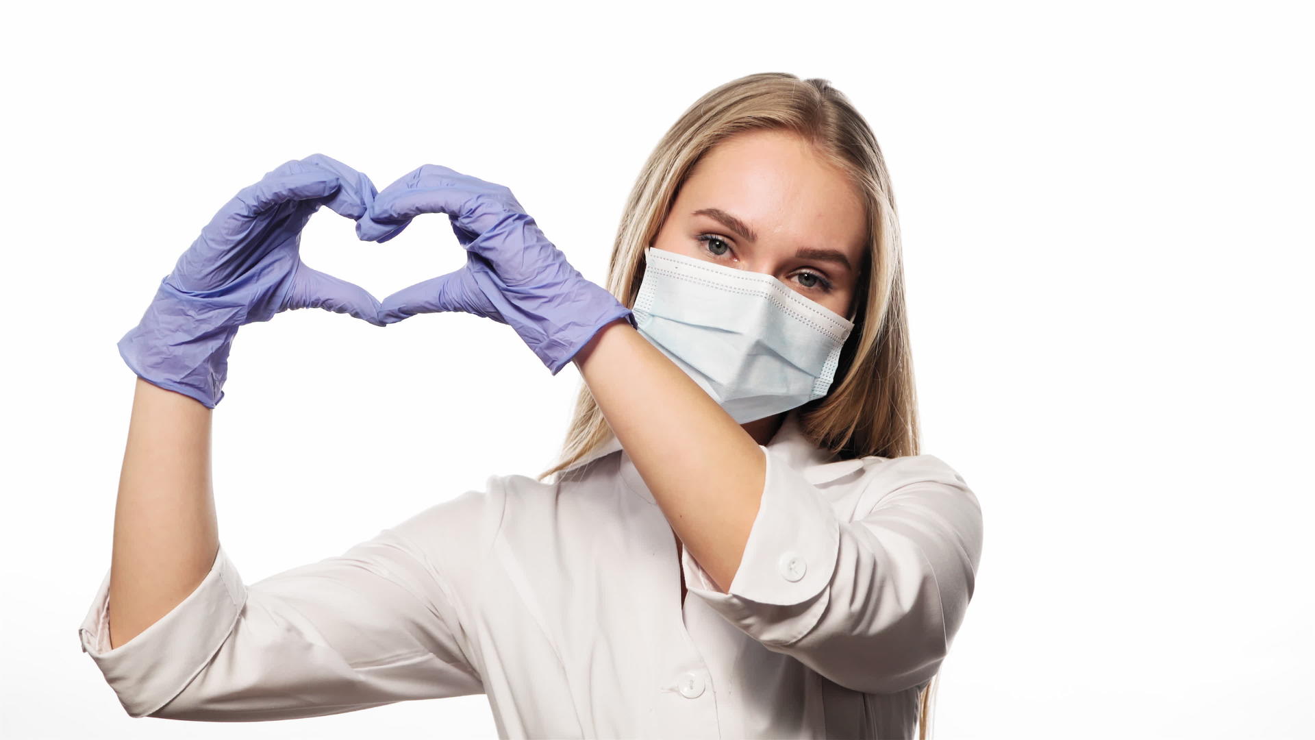 戴着医用面具的年轻护士举起手看着白色背景上的镜头视频的预览图