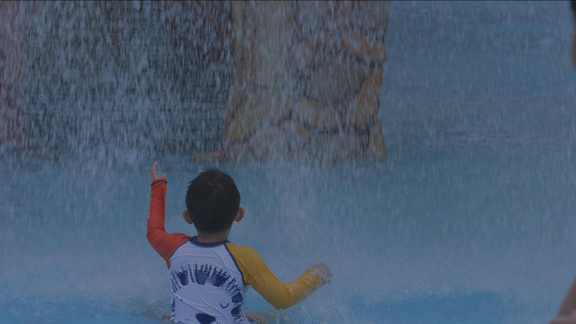 慢镜头升格拍摄4k素材夏天儿童乐园游泳池戏水欢乐冲浪的儿童背影视频的预览图