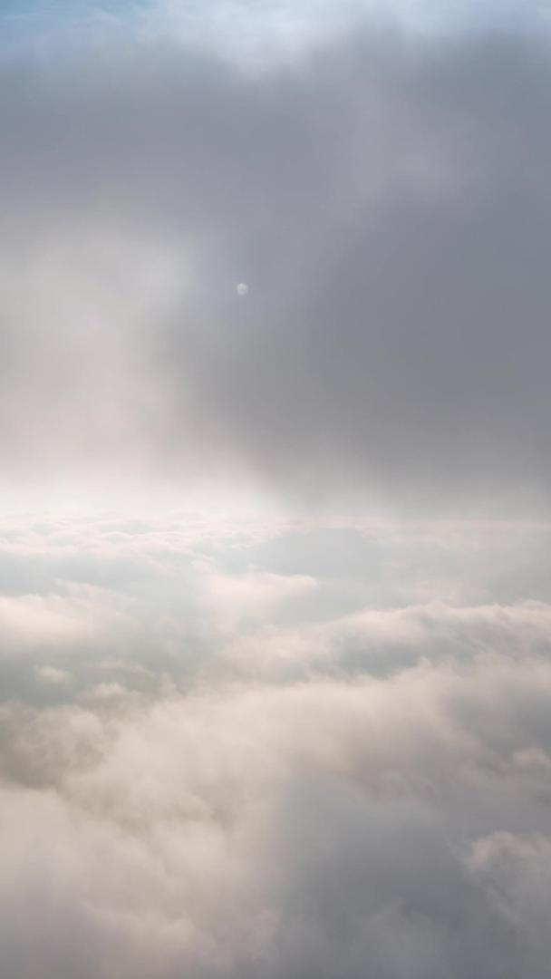 高空航拍穿过云层黎明向太阳日出的黎明阳光前进视频的预览图
