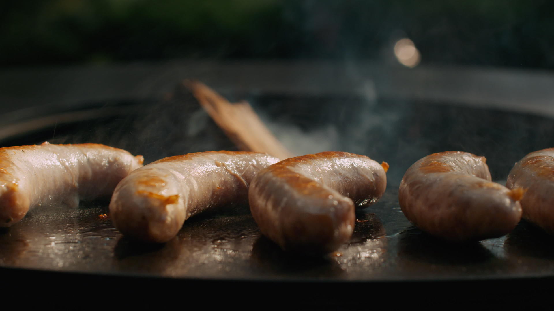 在外面的圆形烤架上准备多汁的香肠烤香肠变黄视频的预览图