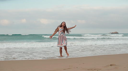 快乐的小女孩在海边跳舞视频的预览图
