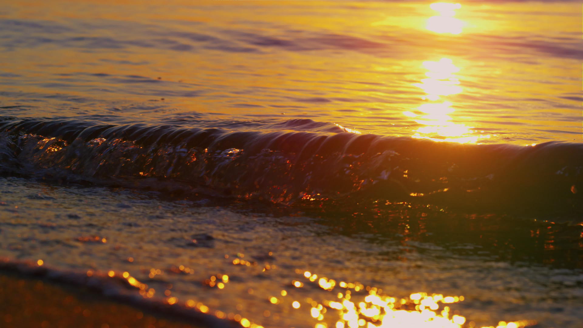 金色早晨日出时 特写海浪溅起沙滩沙滩 视频的预览图