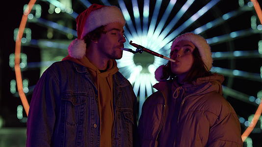 在户外玩得开心的情侣 圣塔帽的同伴庆祝圣诞节视频的预览图