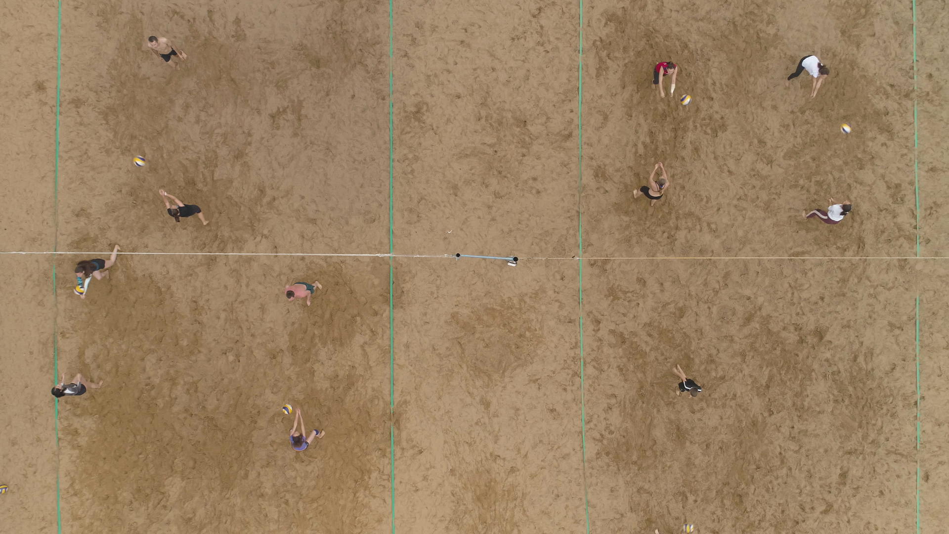 在战场上训练海滩排球在空中垂直从上到下看慢动作视频的预览图