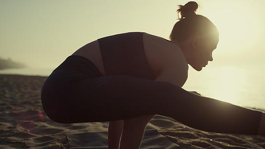 运动女性站立双臂张开双腿练习瑜伽特写视频的预览图