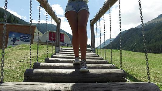 2016年女孩在操场上穿过木桥在木桥上行走视频的预览图