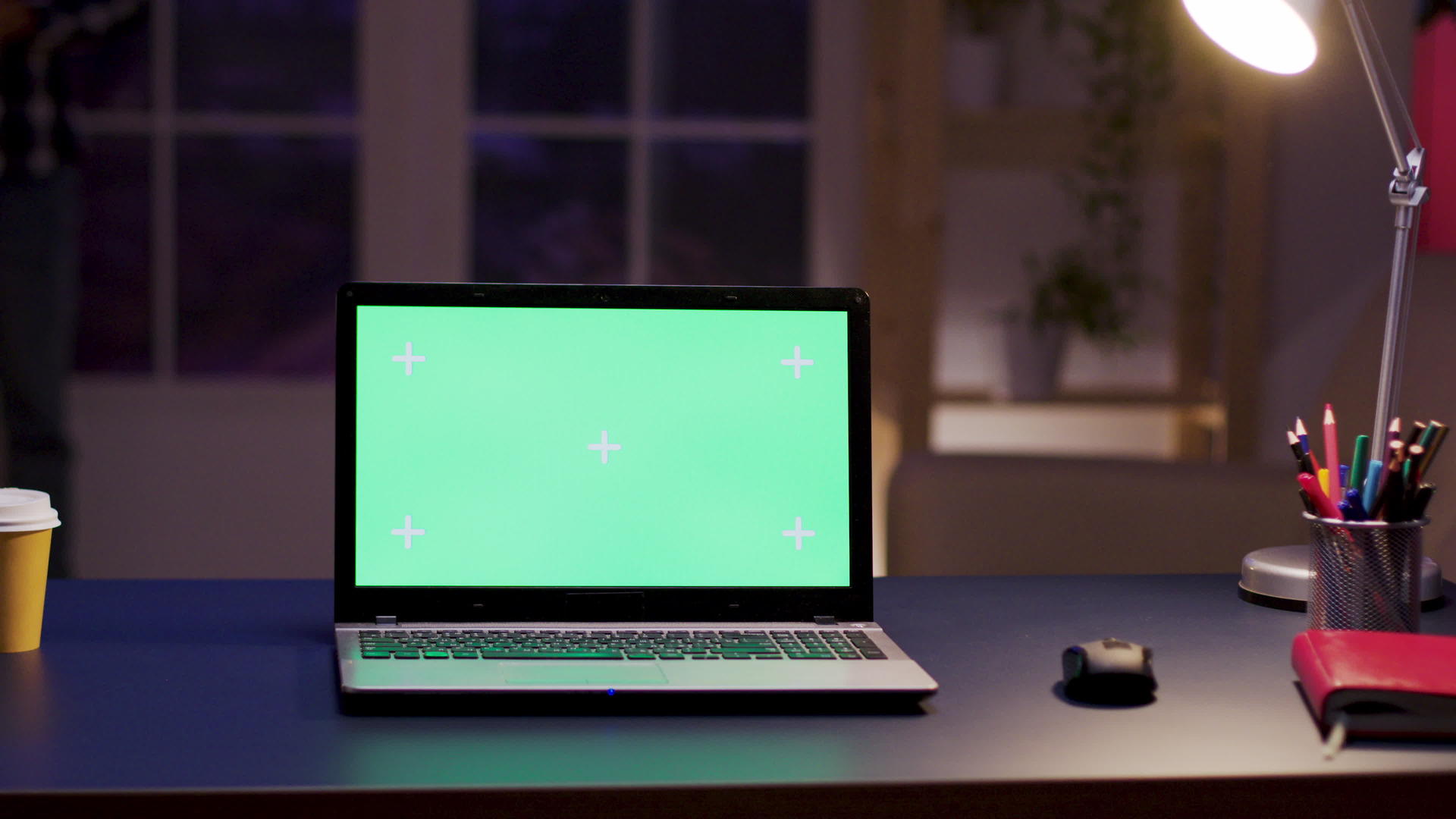 桌子上有一个绿色屏幕的笔记本电脑视频的预览图
